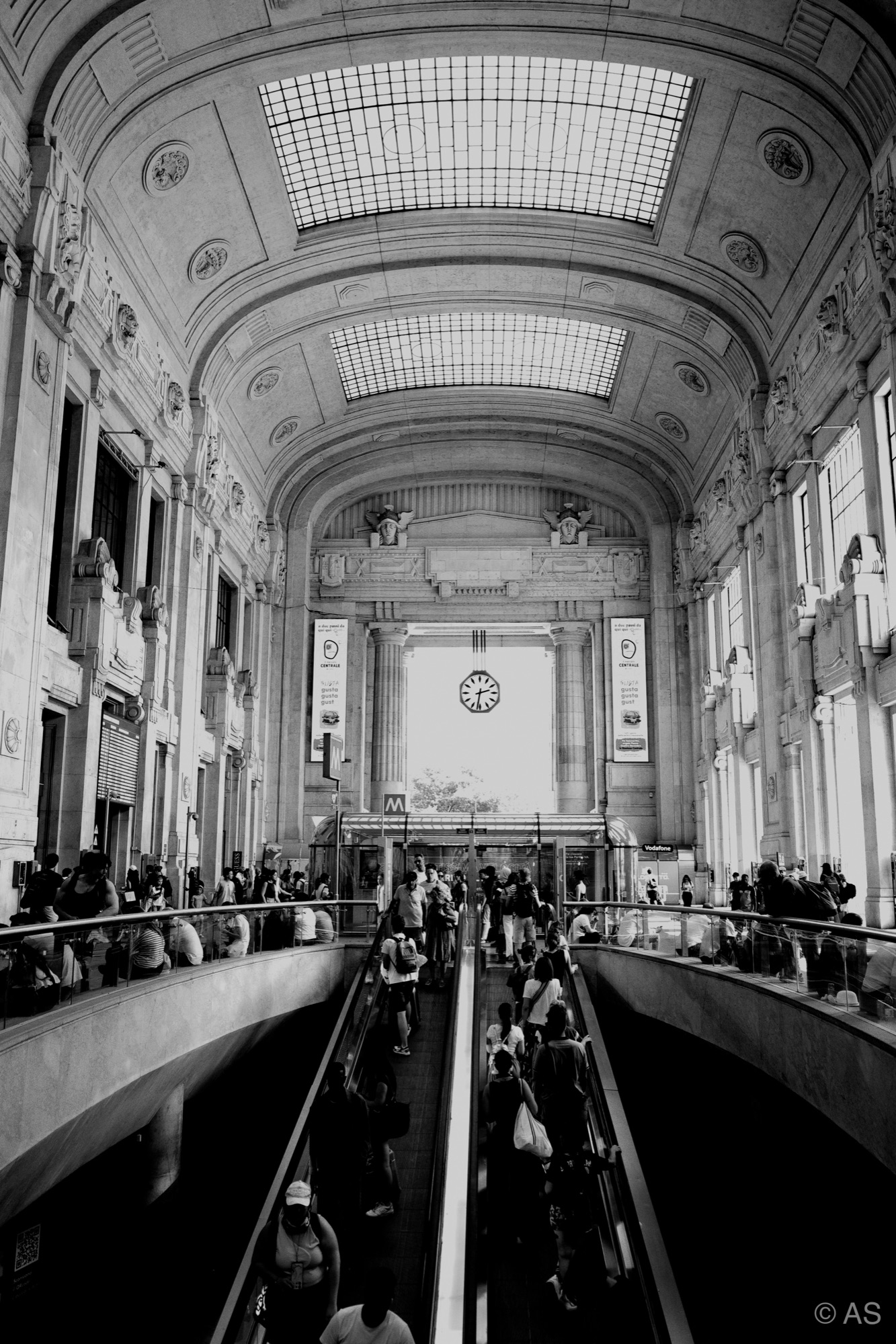 Grand train station interior with escalators and vaulted ceilings